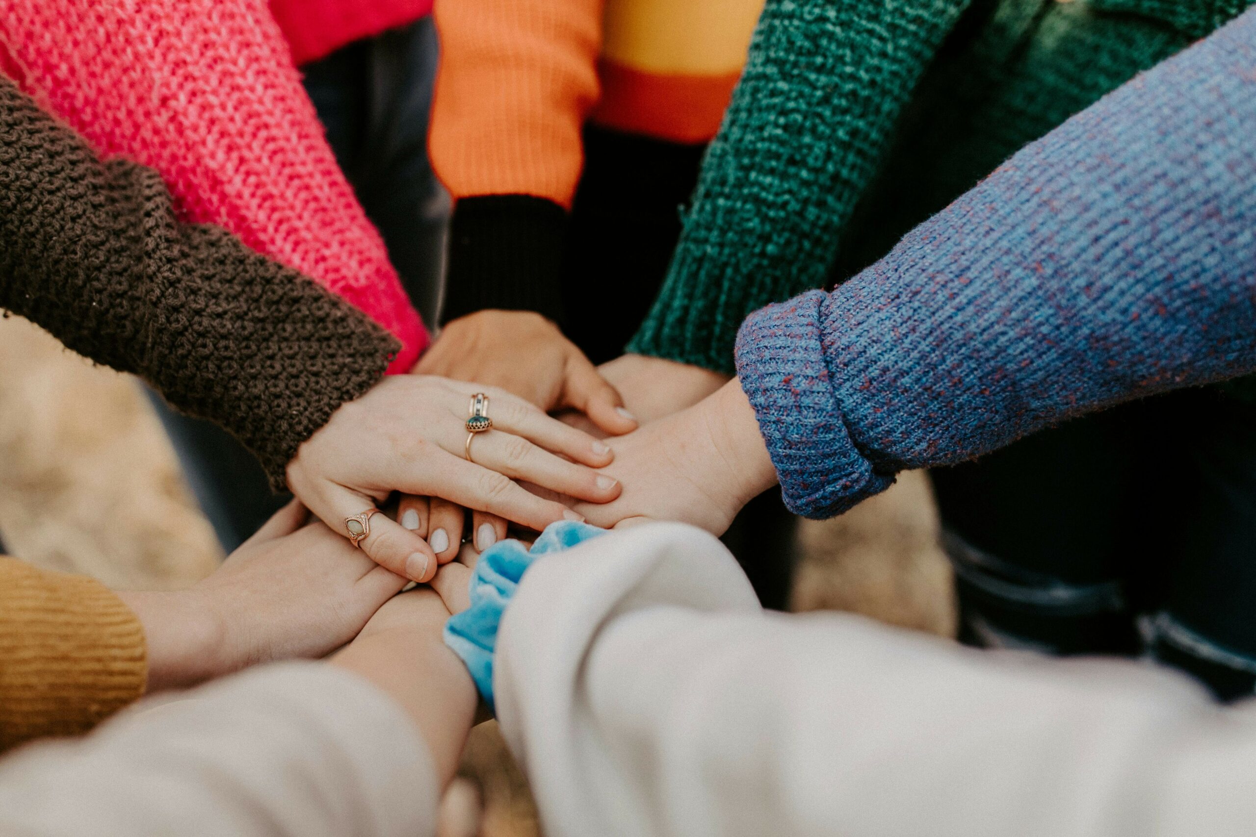 image of a group of people with their hands together